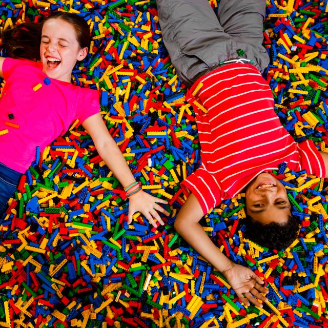 LEGOLAND® Florida Resort kids on bed of legos
