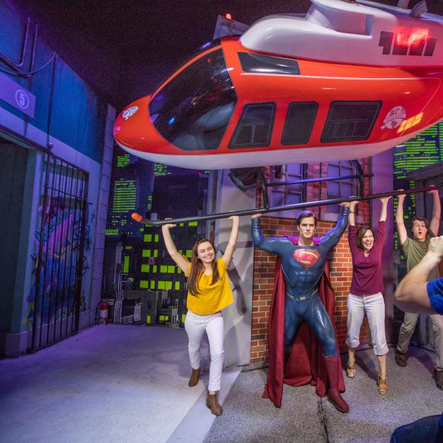 Group poses with Superman at Madame Tussauds