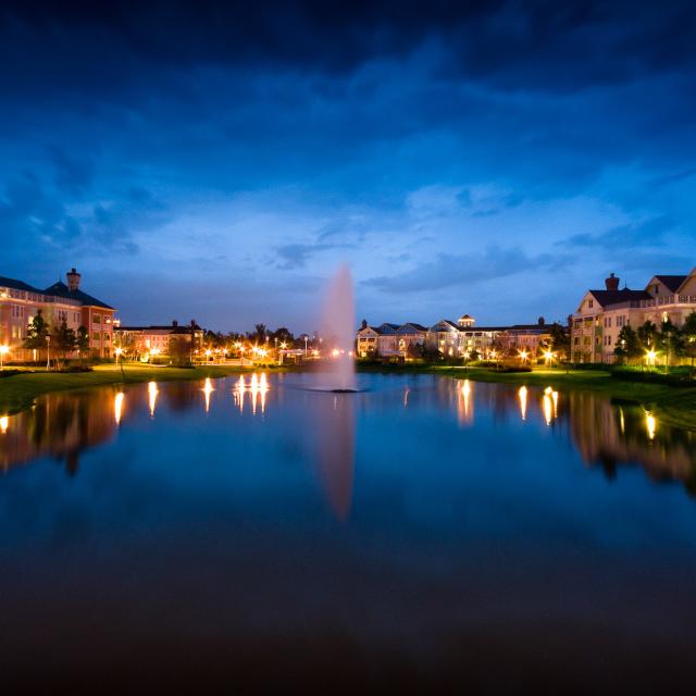 Disney's Saraoga Springs Resort & Spa exterior with lake in foreground at evening