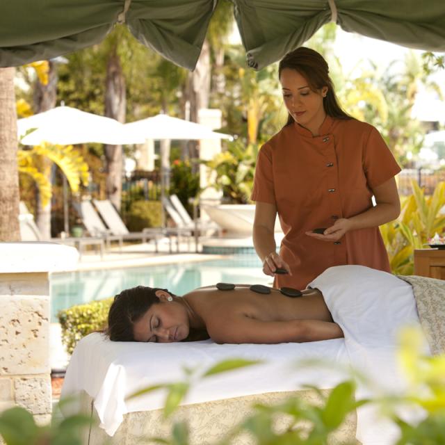 Eforea Spa at Hilton Orlando, woman getting a hot stone massage