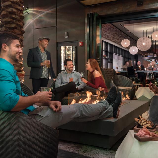 Chroma Modern Bar + Kitchen guests relaxing by firepit