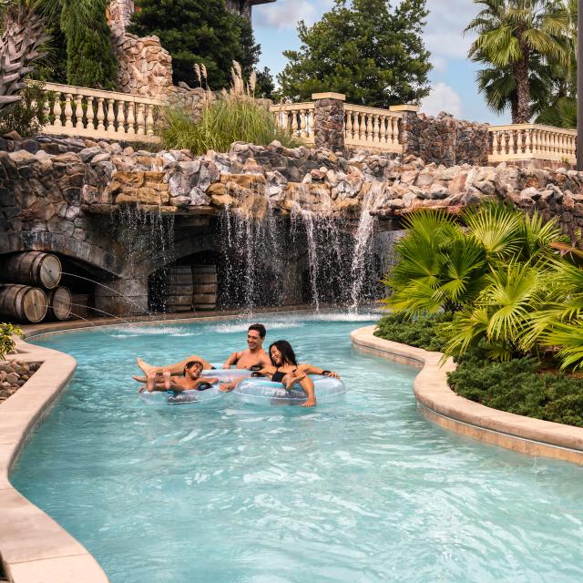 Family floating in the lazy river at the Four Seasons Resort at Walt Disney World Resort
