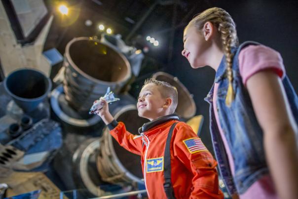 Kennedy Space Center brother and sister looking at Atlantis engine