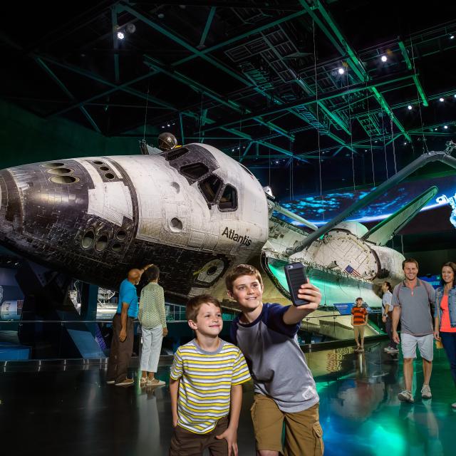 Kennedy Space Center Visitor Complex boys taking selfie with space shuttle