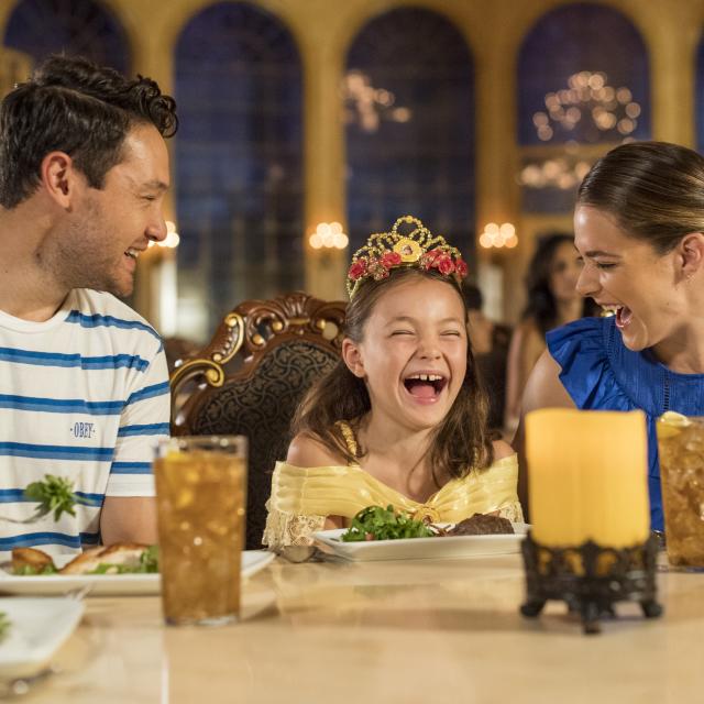 A family at a Be Our Guest dining experience in Magic Kingdom® Park