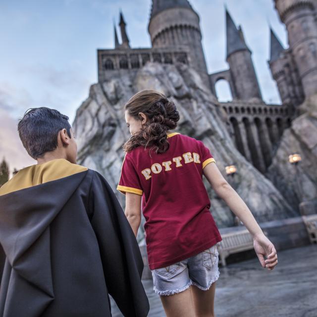 Kids walking through Hogsmeade at the Wizarding World of Harry Potter in Universal Studios Florida
