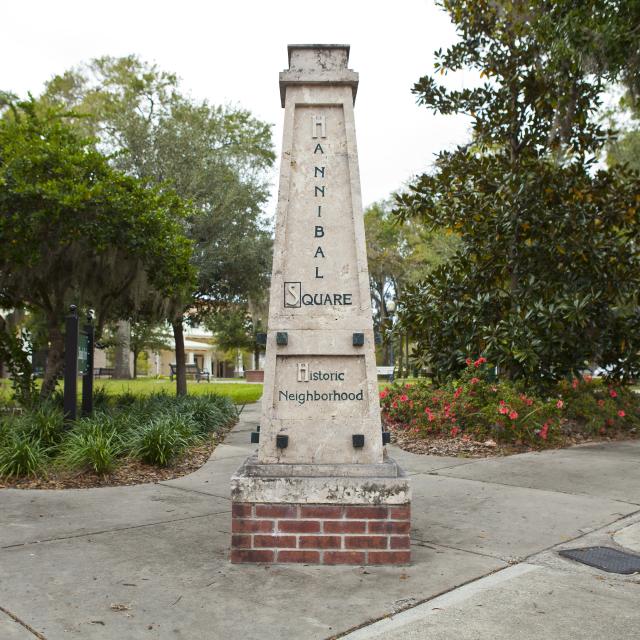 A monument is surrounded by trees and plants, centered in the Hannibal Square district of Winter Park, Florida