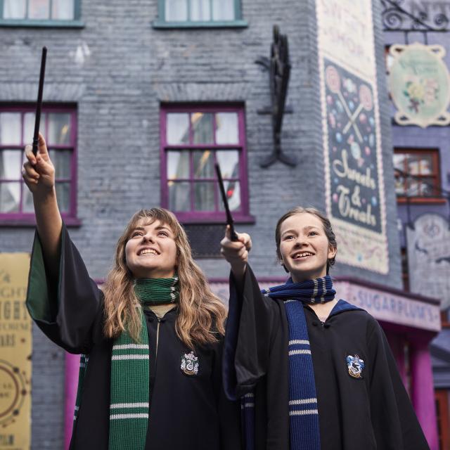 teen girls in diagon alley casting spells with wands