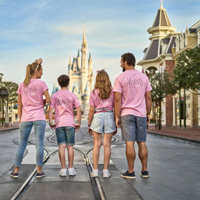 A family posing for a photo on Main Street inside Walt Disney World's Magic Kingdom Park