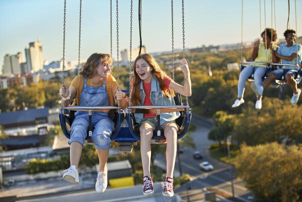 Two friends riding the Orlando Starflyer at ICON Park